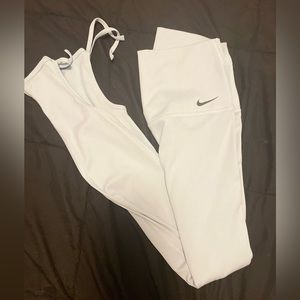 Baby Blue Nike leggings, cut out at the ankles.